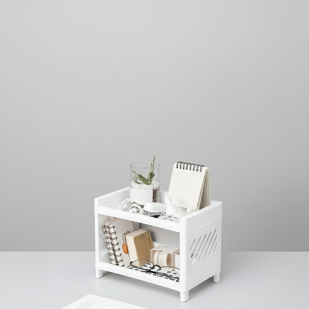 White storage bench with books, a plant, and glasses on a light gray floor.